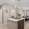 a kitchen with a bar and chairs at Bainbridge Nona North in Orlando, FL