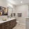 a bathroom with a large mirror at Bainbridge Nona North in Orlando, FL
