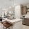 a kitchen with a bar and chairs at Bainbridge Nona North in Orlando, FL